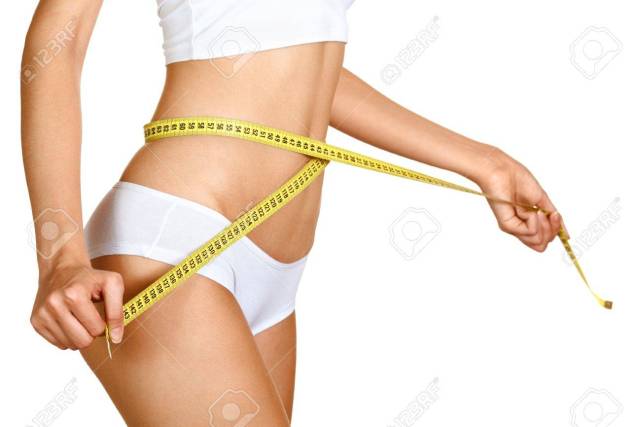 14852709-woman-measuring-her-waistline-perfect-slim-body-diet